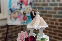bride and groom wedding topper on top of a wedding cake