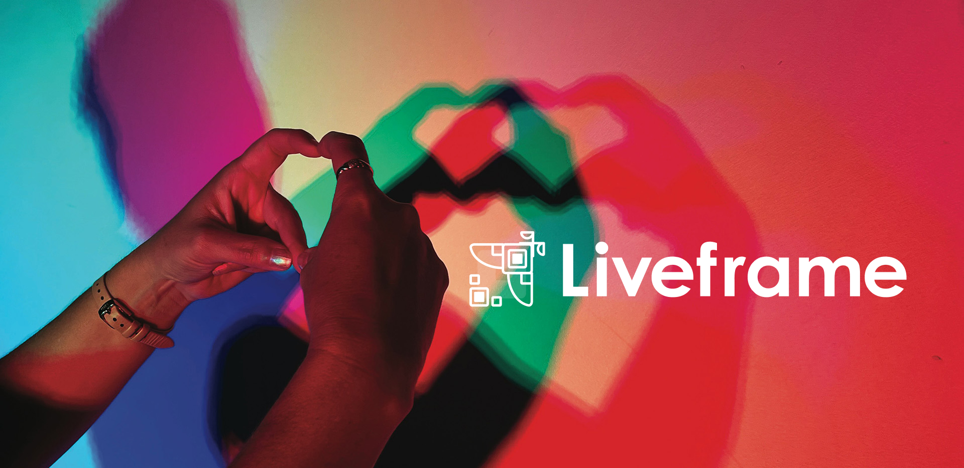 Hands forming a heart shape cast colorful overlapping shadows on a wall, with the Liveframe logo and text in white on the right.