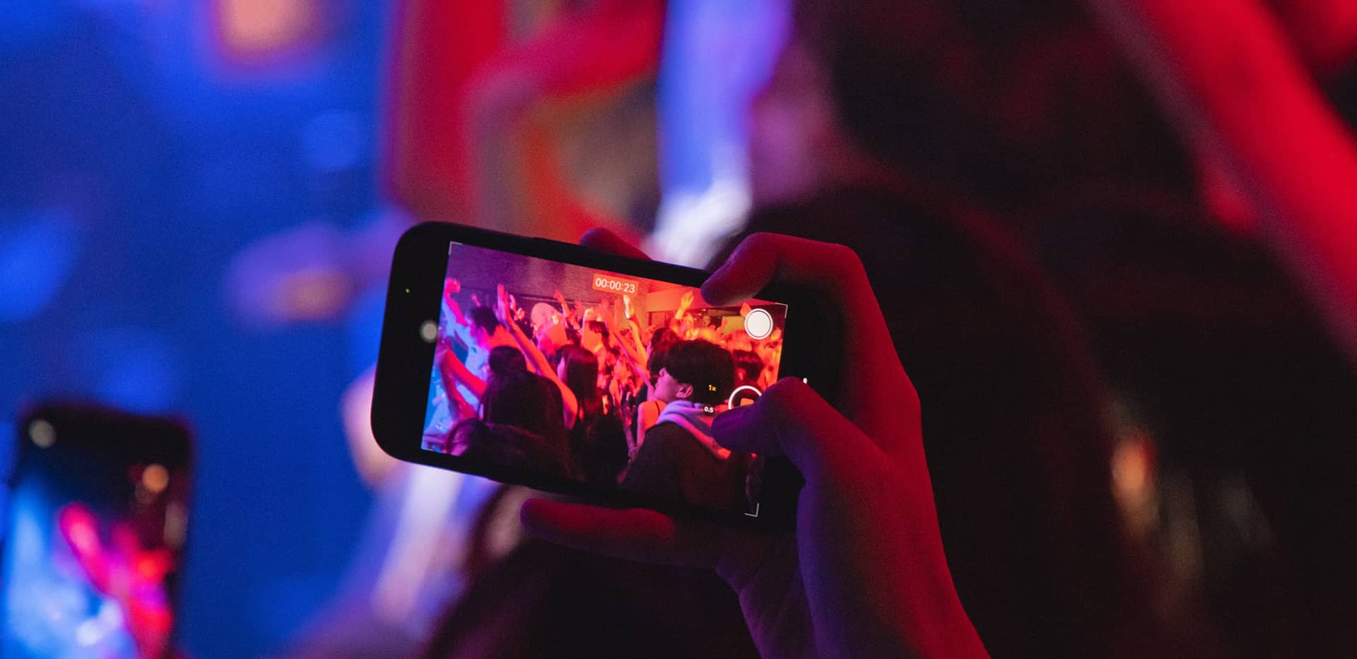 Hands forming a heart shape cast colorful overlapping shadows on a wall, with the Liveframe logo and text in white on the right.